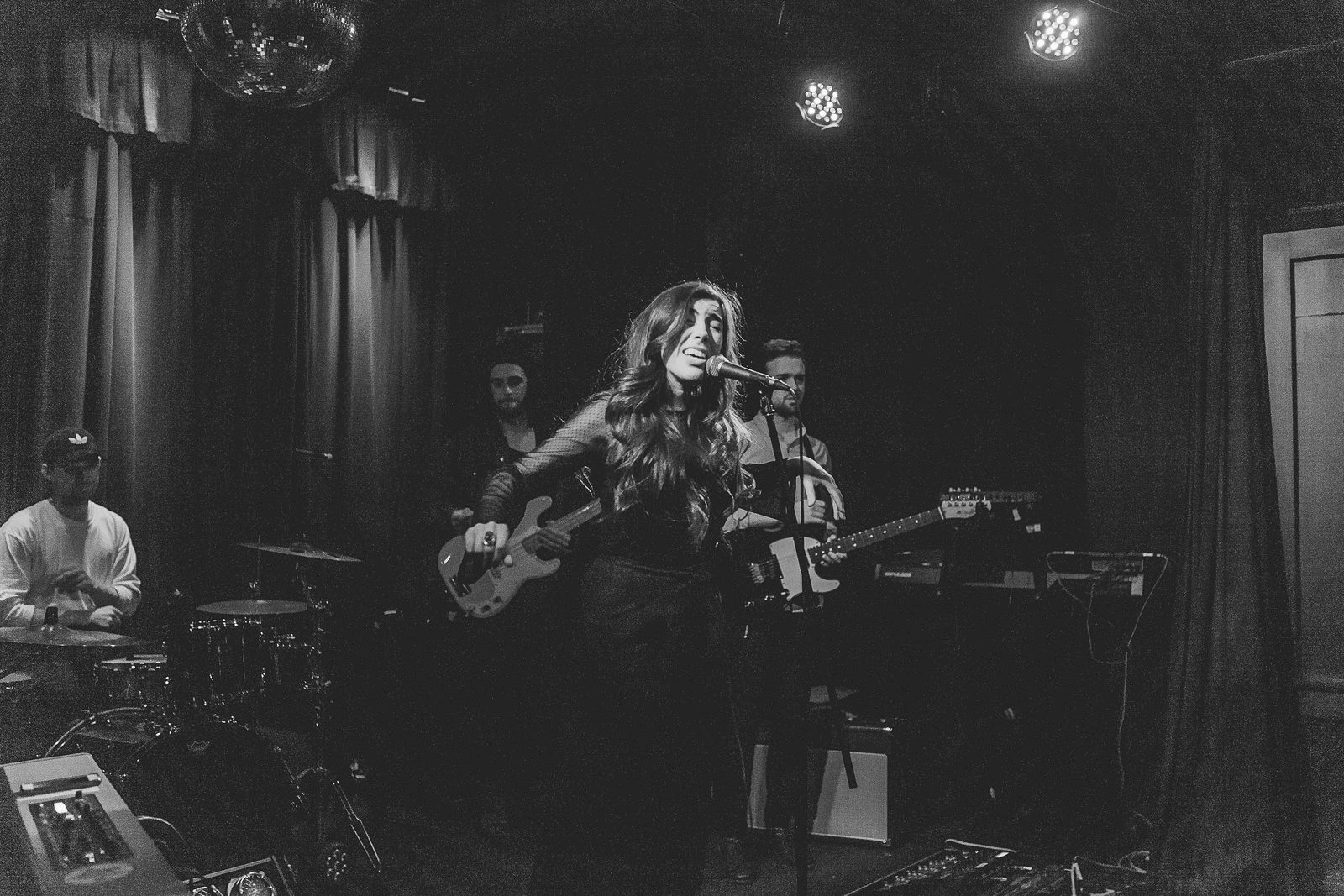 Jess Fairlie singing with her band