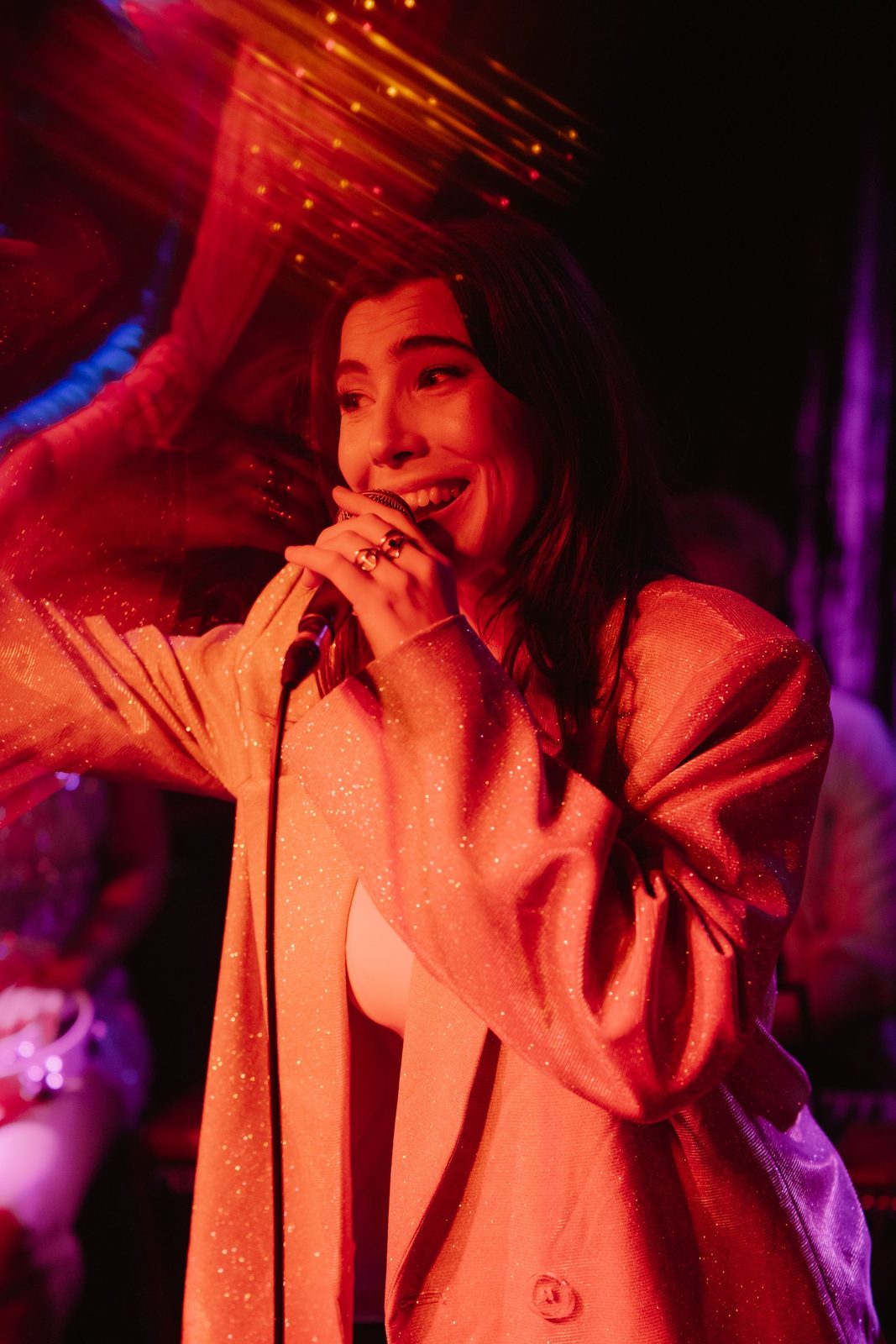 Jess Fairlie on the mic under red light